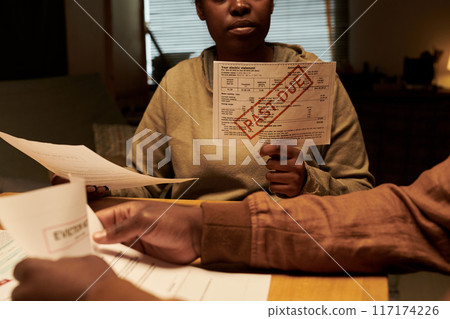 Hands of couple with financial bills 117174226