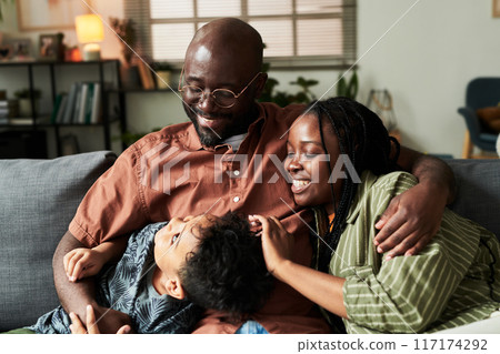 Parents and their son relaxing on couch 117174292