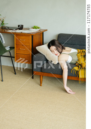 Woman taking a nap on the sofa Woman taking a nap on the sofa 117174785