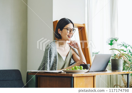 Woman teleworking at home 117174798