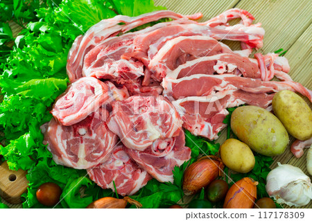 Raw lamb meat with vegetables Raw lamb meat with vegetables 117178309