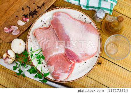 Plate of raw slice of Iberian pork secret and seasonings 117178314