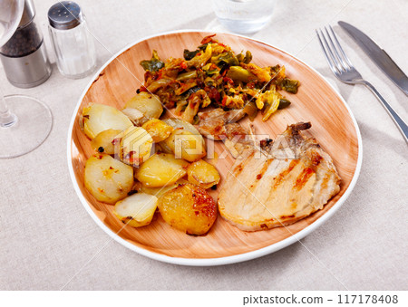 Pork meat with roasted potatoes and stewed cabbage Pork meat with roasted potatoes and stewed cabbage 117178408