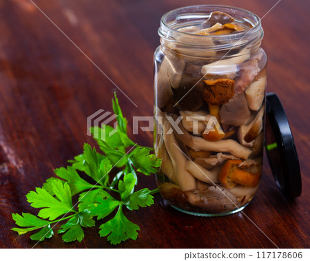 Assorted marinated mushrooms in glass jar 117178606