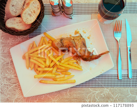 Braised rabbit served with potato garnish 117178893