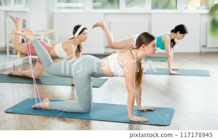 Group of young women doing pilates with loop 117178945