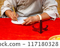 Close up photo of human hand writing by calligraphy brush pen 117180328