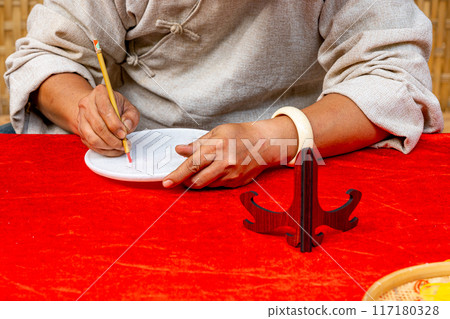 Close up photo of human hand writing by calligraphy brush pen 117180328