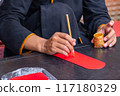 Human using calligraphy brush painting on lucky money red envelope 117180329