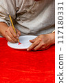 Vertical photo of human hand doing handwriting by calligraphic brush pen  117180331