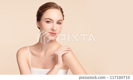 Beautiful young woman with clean fresh skin on beige background, Face care, Facial treatment, Cosmetology, beauty and spa, women portrait. 117180710