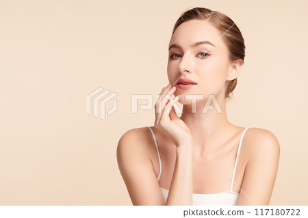Beautiful young woman with clean fresh skin on beige background, Face care, Facial treatment, Cosmetology, beauty and spa, women portrait. 117180722