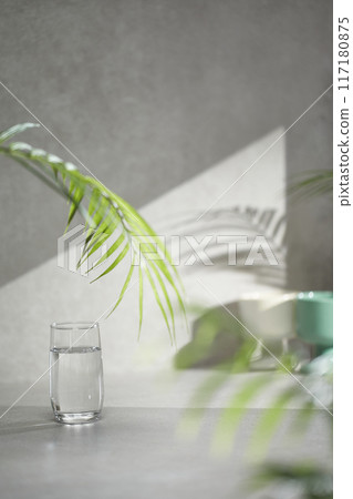 A gray-toned tile background with various props with sunlight coming through the window. A gray-toned tile background with various props with sunlight coming through the window. 117180875