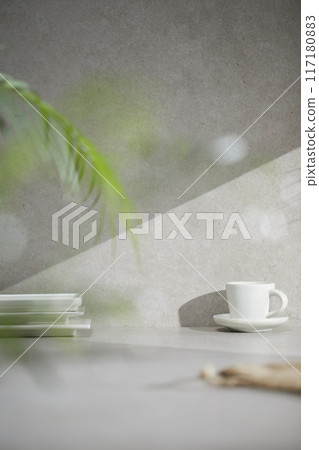 A gray-toned tile background with various props with sunlight coming through the window. A gray-toned tile background with various props with sunlight coming through the window. 117180883