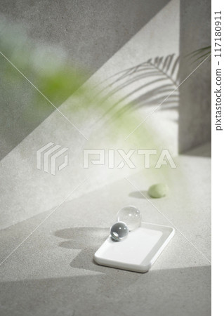 A gray-toned tile background with various props with sunlight coming through the window. A gray-toned tile background with various props with sunlight coming through the window. 117180911