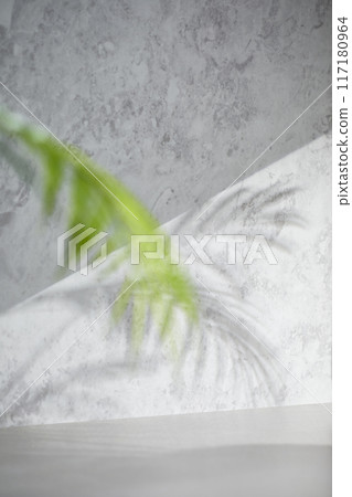 A gray-toned tile background with various props with sunlight coming through the window. A gray-toned tile background with various props with sunlight coming through the window. 117180964