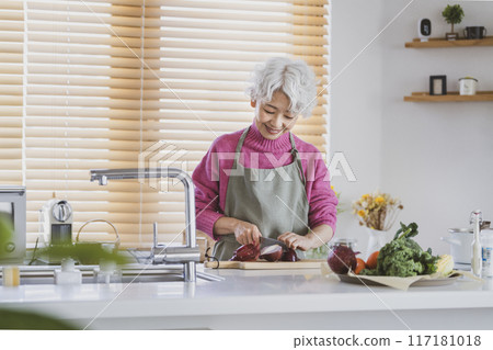 Senior woman cooking Senior woman cooking 117181018