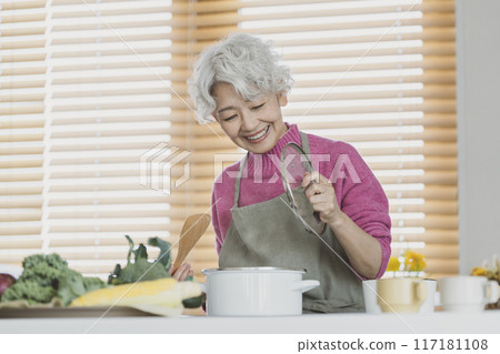 Senior woman cooking 117181108