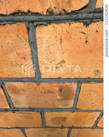 Red brick wall with black joints. Inclined Close up. 117182456