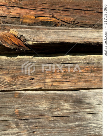Old log wall. The logs are cracked and eaten by bugs. 117183066