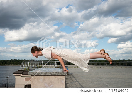 Girl in the city did a horizontal handstand 117184052