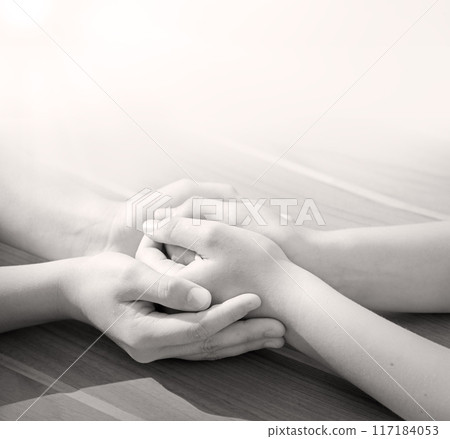 Close-up view of comforting hands 117184053