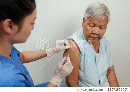 doctor make injection vaccine to senior woman doctor make injection vaccine to senior woman 117184327