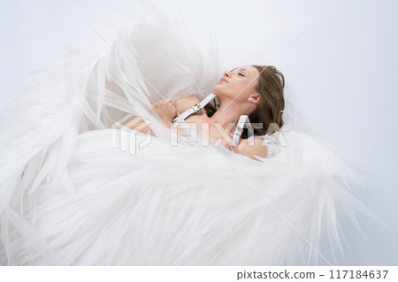 Woman Laying naked in White wings 117184637