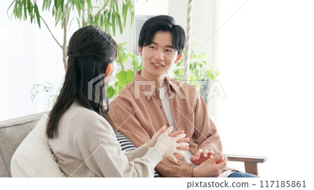 Couple talking in the living room Couple talking in the living room 117185861