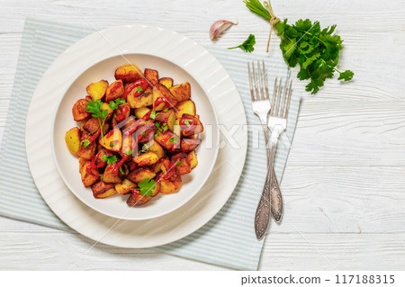 fried spanish potatoes with paprika sauce in bowl 117188315