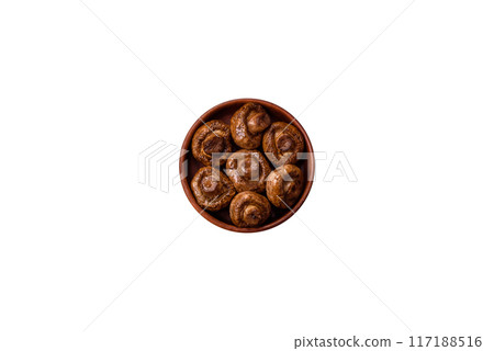 Delicious juicy whole champignons baked on the grill with salt and spices 117188516