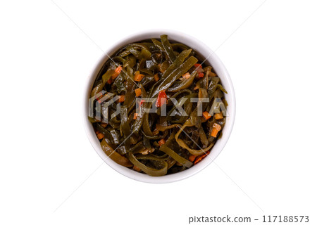 Delicious marinated seaweed with paprika, spices and salt on a dark concrete background Delicious marinated seaweed with paprika, spices and salt on a dark concrete background 117188573