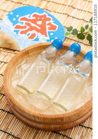 Ramune soda and festival fans cooled in a bucket of water and ice Ramune soda and festival fans cooled in a bucket of water and ice 117188910