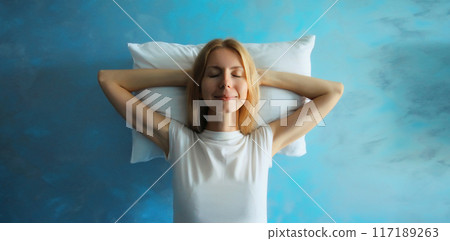 Healthy sleep, happy relaxed sleepy young woman lying on white soft comfortable pillow Healthy sleep, happy relaxed sleepy young woman lying on white soft comfortable pillow 117189263
