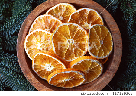 Top view of dried orange slices in wooden box 117189363