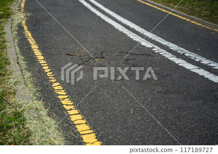 Broken asphalt on the bike path Broken asphalt on the bike path 117189727