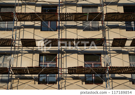 Scaffolding stands against the wall of the building. Restoration of the building 117189854
