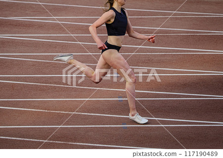 female athlete running sprint race in background of intersecting marking lines track female athlete running sprint race in background of intersecting marking lines track 117190489