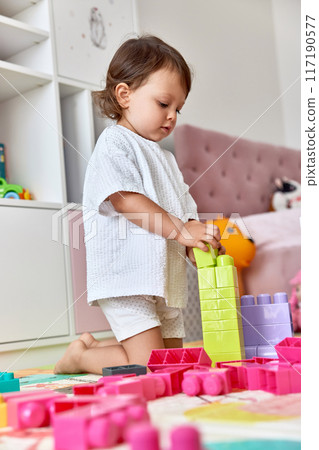 cute baby girl playing with colorful toys bricks at home cute baby girl playing with colorful toys bricks at home 117190577