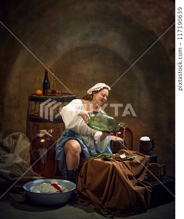 Woman brewer, dressed old-fashion clothes, pouring drink to glass standing on table with plate of simple food at ancient pub on vintage background. Woman brewer, dressed old-fashion clothes, pouring drink to glass standing on table with plate of simple food at ancient pub on vintage background. 117190639