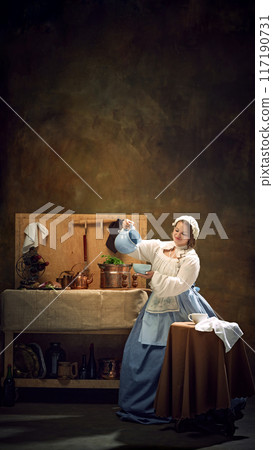 Poster. Young chubby woman in historical dress holds blue pitcher, surrounded by vintage kitchenware and herbs. 117190731