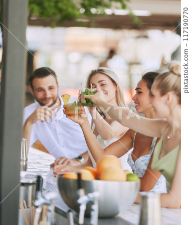 Happy,smiling young people, man and woman enjoying refreshing drinks, delicious cocktail in modern outdoor bar. Cheers Happy,smiling young people, man and woman enjoying refreshing drinks, delicious cocktail in modern outdoor bar. Cheers 117190770