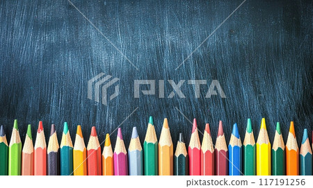 Colorful Pencils, Erasers, and Markers Neatly Arranged in Front of a Blank Blackboard | Back-to-School Classroom Supplies | Creative Education Concept 117191256