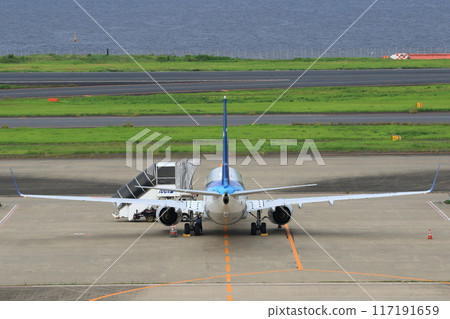 Passenger plane moored offshore Passenger plane with ramp car attached Passenger plane moored offshore Passenger plane with ramp car attached 117191659