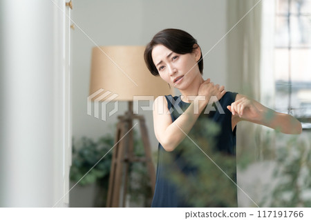 Woman massaging shoulders, stiff shoulders Woman massaging shoulders, stiff shoulders 117191766