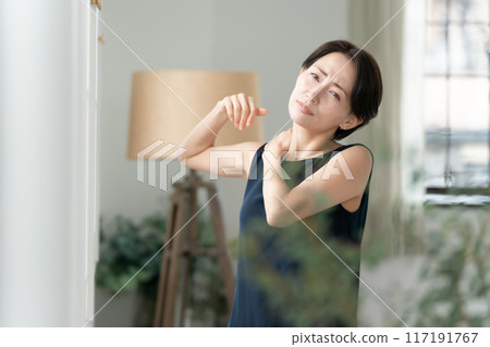 Woman massaging shoulders, stiff shoulders 117191767