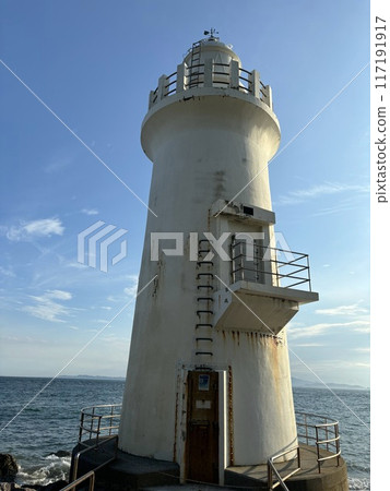 lighthouse sticking out into the sea 117191917