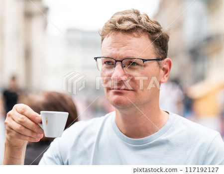 Portrait of a 45 yo white man drinking a cup of espresso coffee, Brussels, Belgium 117192127