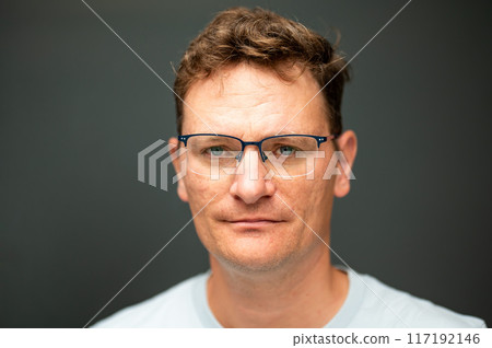 Portrait of a 45 yo white man against a solid grey background, Brussels, Belgium 117192146