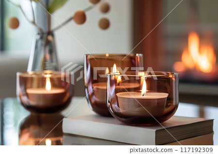 Creating a cozy atmosphere at home with candles and a fireplace for a peaceful and warm setting 117192309